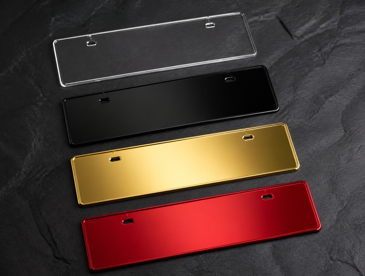 Crystal clear, gloss black, gold mirror and candy red acrylic plate blanks on dark slate